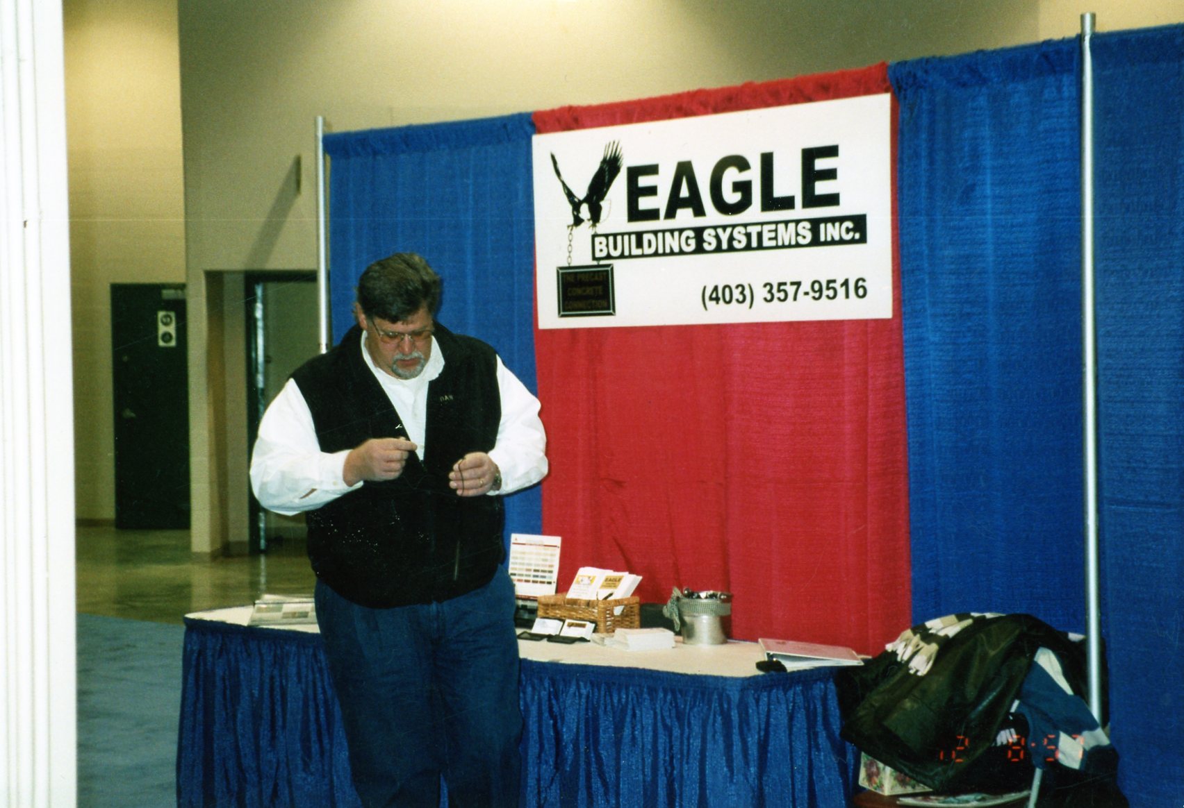 Dan Haan in 2000, standing in front of an Eagle Builders booth