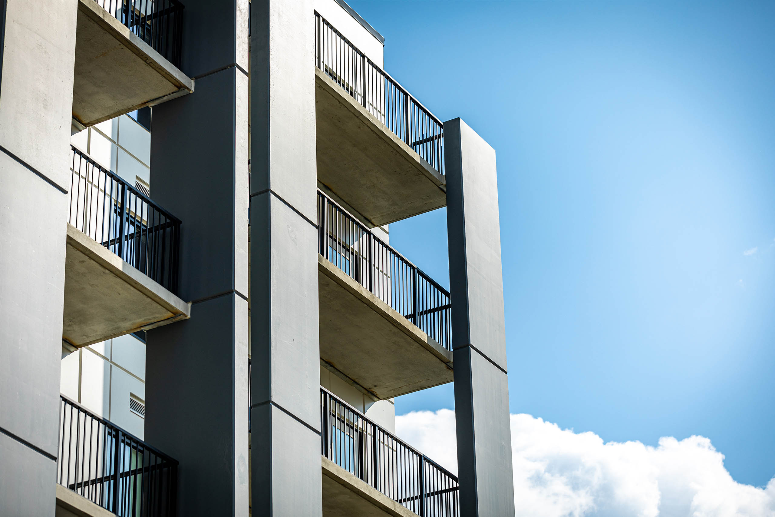 View of multiple balconies from the side of the Century Gardens building on a sunny day