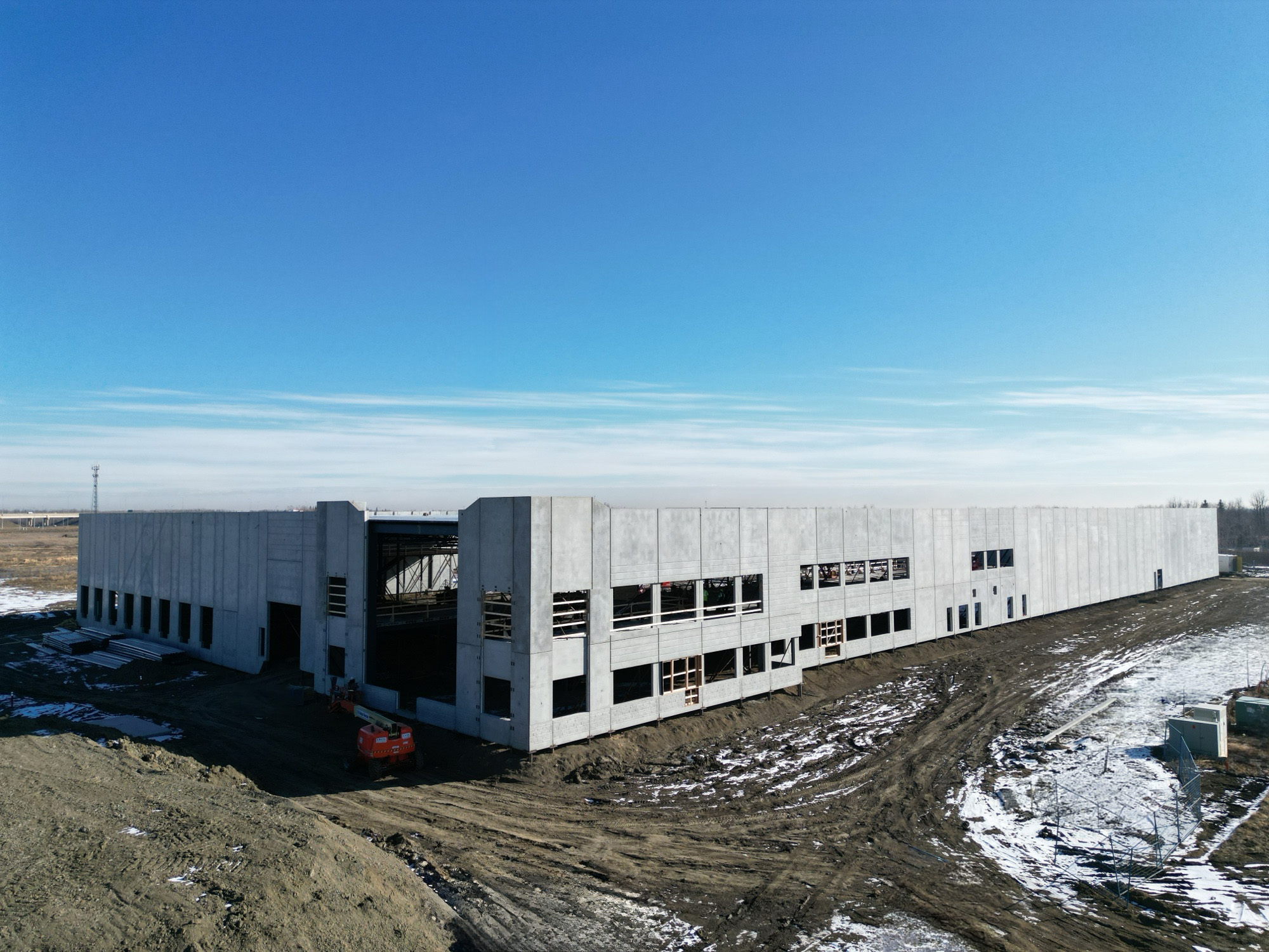 Exterior view of the Kohltech building being constructed on a sunny winter day