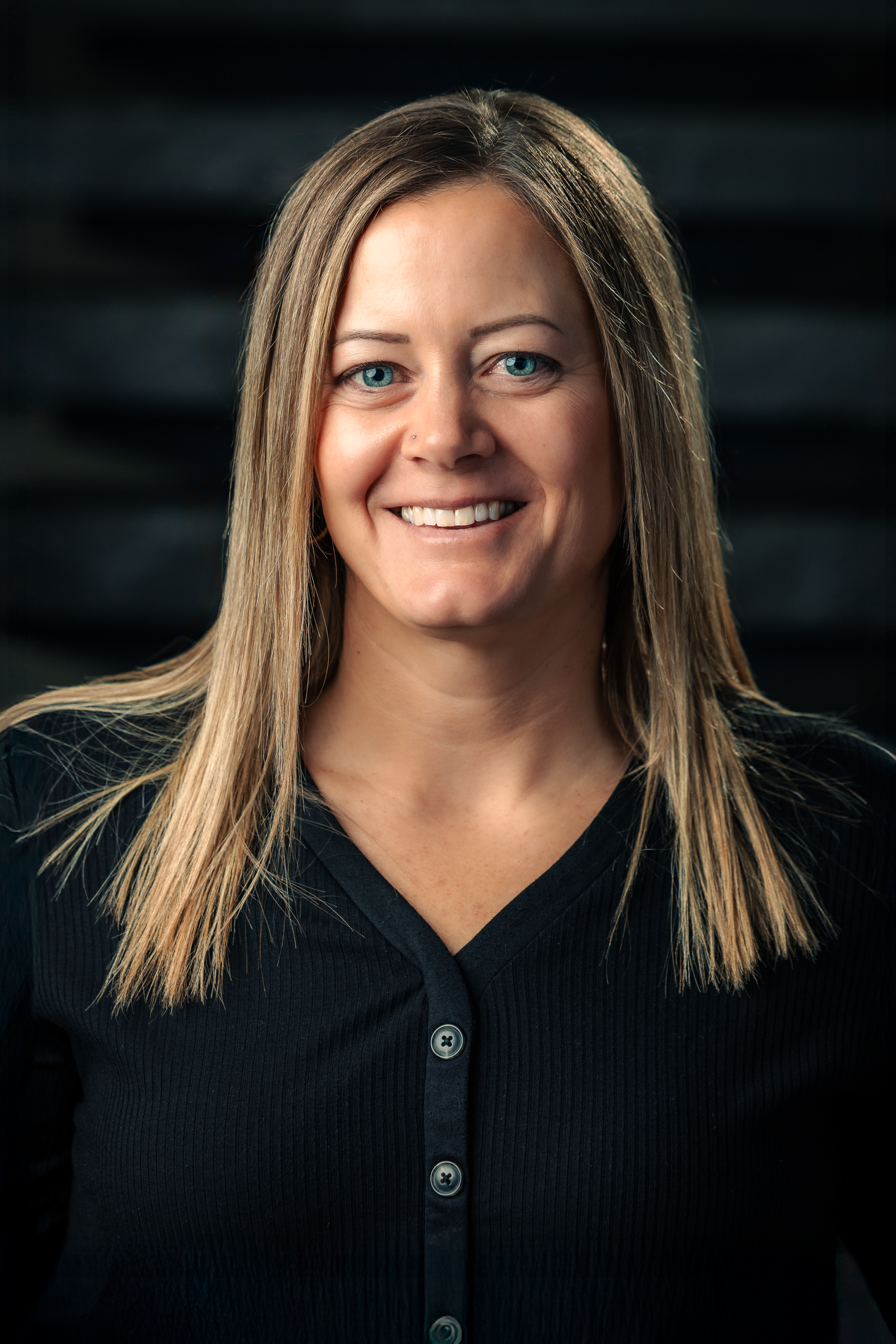 Headshot of Becky Kooiker, smiling warmly at the camera