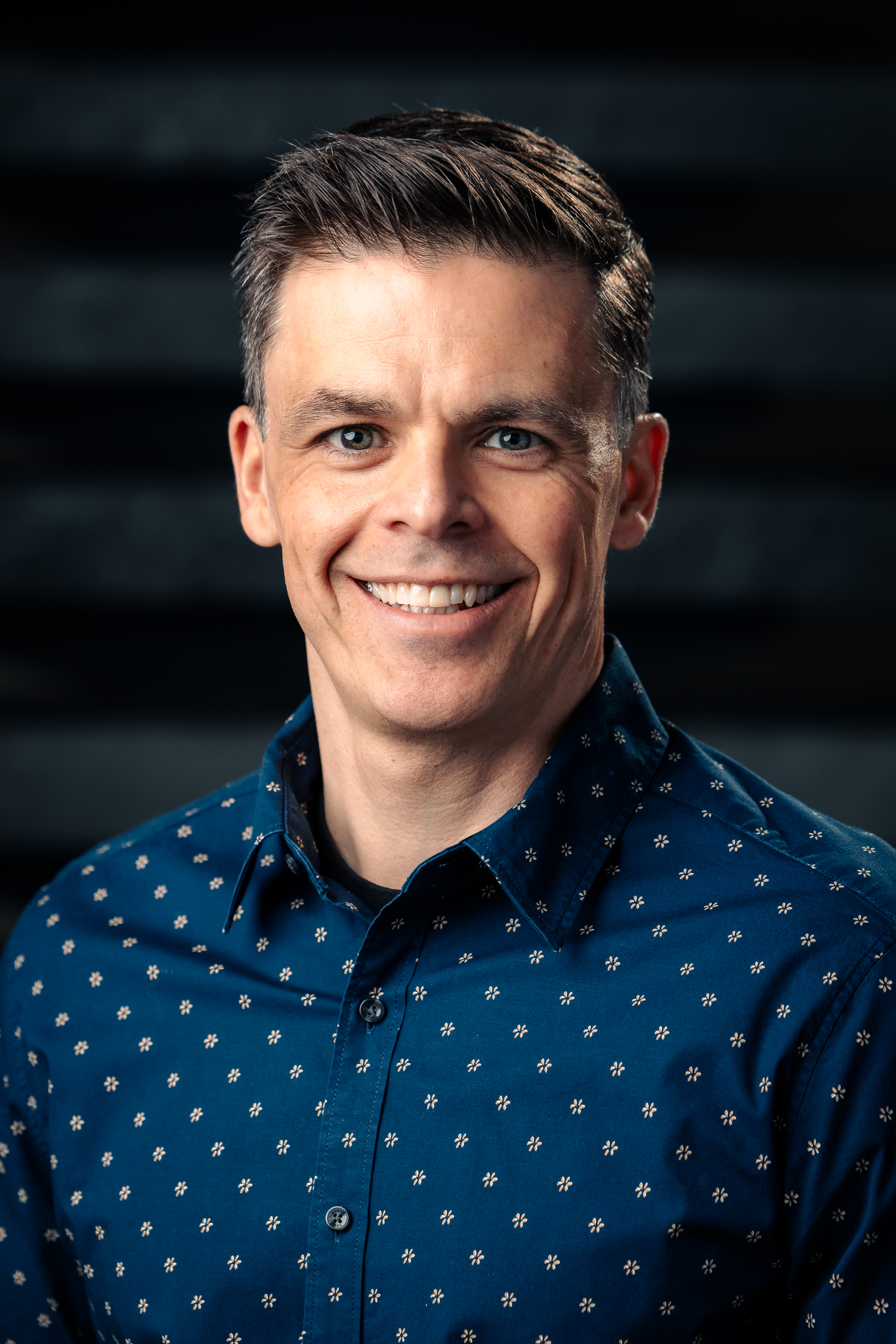 Headshot of Bryce Strilchuk, smiling warmly at the camera
