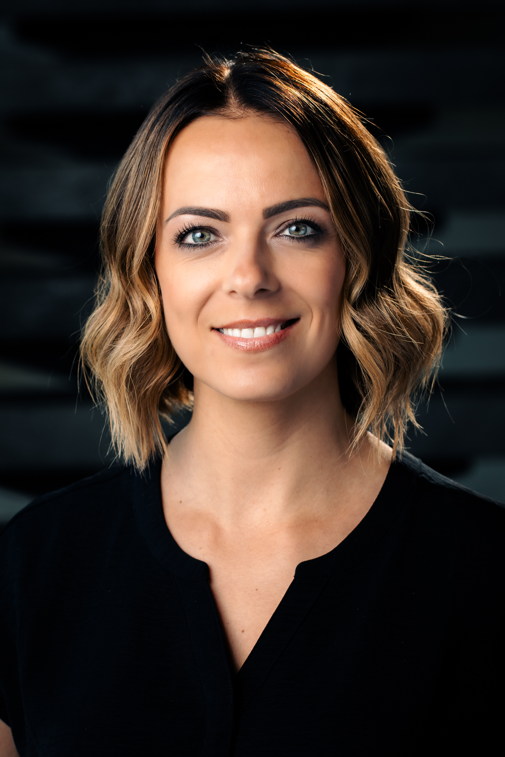 Headshot of Roxanne Rose, smiling warmly at the camera